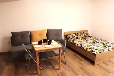a room with a couch and a table and a bed at Apartamenty Zator Energy Rest in Zator