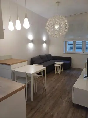 a living room with a couch and a table at Studio Przemyska Cracow's Kazimierz in Kraków