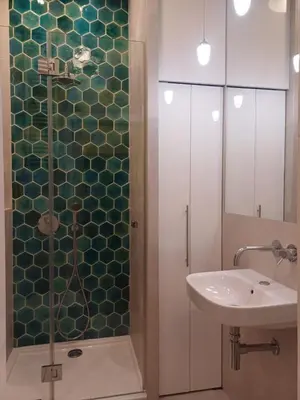 a bathroom with a glass shower and a sink at Studio Przemyska Cracow's Kazimierz in Kraków