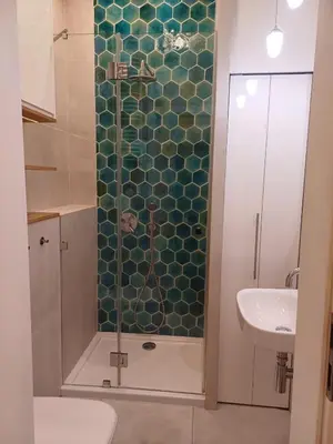 a bathroom with a shower with a toilet and a sink at Studio Przemyska Cracow's Kazimierz in Kraków