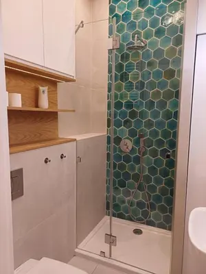 a bathroom with a shower with a glass door at Studio Przemyska Cracow's Kazimierz in Kraków