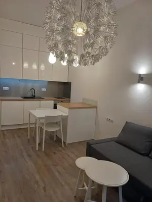 a living room with a couch and a table and chairs at Studio Przemyska Cracow's Kazimierz in Kraków