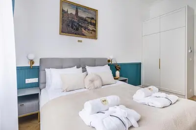 a bedroom with a large bed with towels on it at BOB Elite Apartments in Kraków