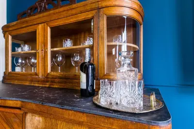 a bottle of wine and glasses on a counter at BOB Elite Apartments in Kraków
