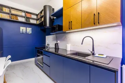 a white bathroom with a sink and a shower at BOB Elite Apartments in Kraków