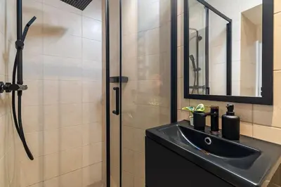 a bathroom with a sink and a shower at Old Town Studio Wawel in Kraków