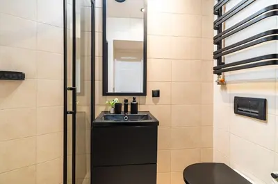 a bathroom with a sink and a mirror at Old Town Studio Wawel in Kraków