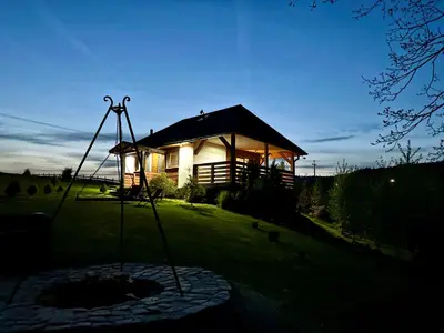 a cabin with a fire pit in front of it at Bąbelkowa Chata Beskidy Domek z Balią Jacuzzi in Gilowice