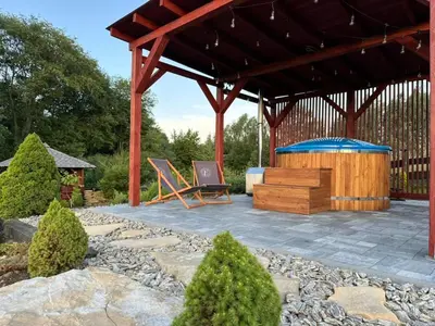 a pavilion with a picnic table and a bench at Bąbelkowa Chata Beskidy Domek z Balią Jacuzzi in Gilowice