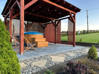 a wooden pavilion with a playground in a garden at Bąbelkowa Chata Beskidy Domek z Balią Jacuzzi in Gilowice