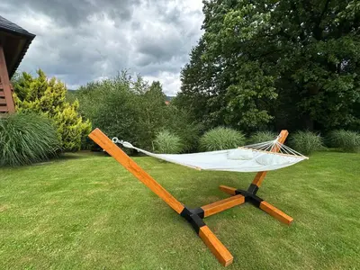 a hammock on a stand in a yard at Bąbelkowa Chata Beskidy Domek z Balią Jacuzzi in Gilowice