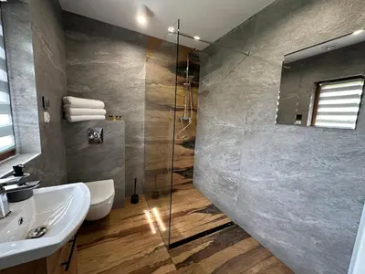 a bathroom with a sink and a glass shower at Bąbelkowa Chata Beskidy Domek z Balią Jacuzzi in Gilowice