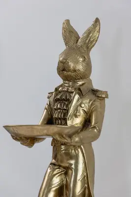 a bronze statue of a rabbit holding a plate at Rakowicka Modern Studio in Downtown Cracow by Rent like home in Kraków