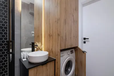 a bathroom with a washing machine and a sink at Rakowicka Modern Studio in Downtown Cracow by Rent like home in Kraków