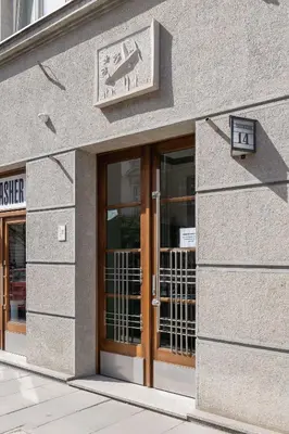 a building with a sign over the door of a store at Rakowicka Modern Studio in Downtown Cracow by Rent like home in Kraków