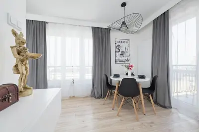 a dining room with a table and chairs in a room at Rakowicka Modern Studio in Downtown Cracow by Rent like home in Kraków