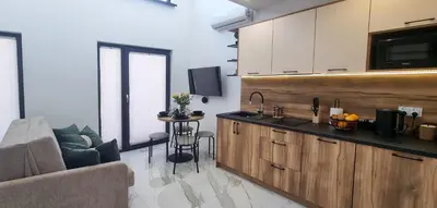 a kitchen with a couch and a table in a room at ZATOR Domki INTERSTYL, Energylandia in Zator
