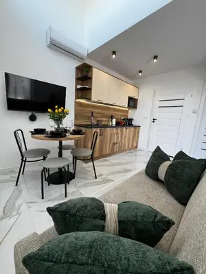 a living room with a couch and a table at ZATOR Domki INTERSTYL, Energylandia in Zator