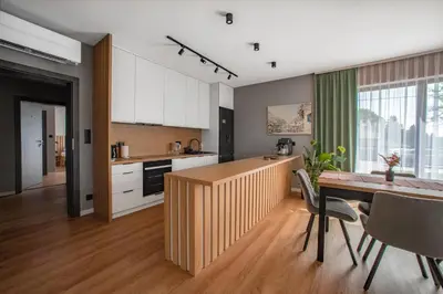 a kitchen and dining room with a table and chairs at Willa Olimpia in Podzamcze