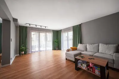 a living room with a couch and a table at Willa Olimpia in Podzamcze