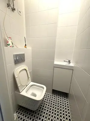 a kitchen with a sink and a counter top at YOONIK APARTMENTS in Kraków