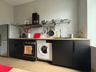 a small bathroom with a toilet and a sink at YOONIK APARTMENTS in Kraków