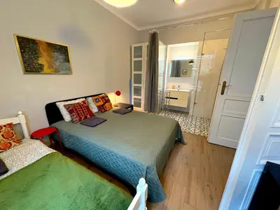 a small kitchen with a wooden table and chairs at YOONIK APARTMENTS in Kraków