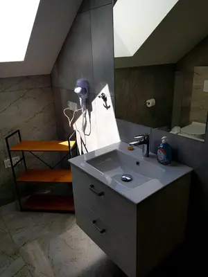 a bathroom with a sink and a mirror at Surzynówka in Stryszawa