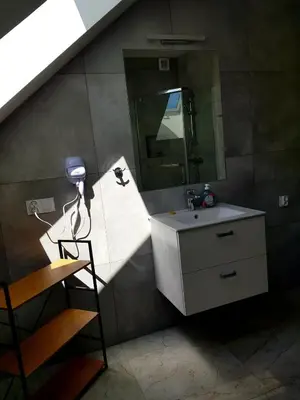 a bathroom with a sink and a mirror at Surzynówka in Stryszawa