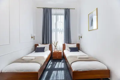 two twin beds in a room with a window at BoB Elite - Szpitalna in Kraków