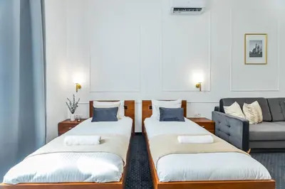 a living room with two beds and a couch at BoB Elite - Szpitalna in Kraków