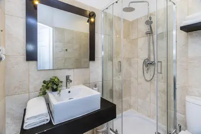 a bathroom with a sink and a shower at BoB Elite - Szpitalna in Kraków
