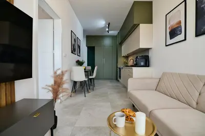 a living room with a couch and a table at Apartament SUNSET 79 by Housine in Zator