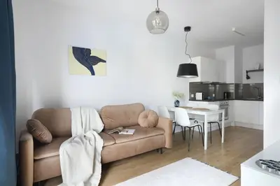 a living room with a couch and a table at Malila Premium Apartments Cracow City Center Pawia 34 in Kraków