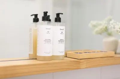 three bottles sitting on a wooden shelf in a kitchen at Malila Premium Apartments Cracow City Center Pawia 34 in Kraków