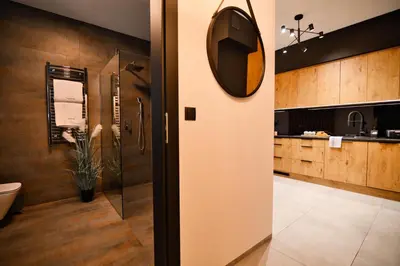 a bathroom with a toilet and a mirror on the wall at Apartament Zator 5 by Housine in Zator