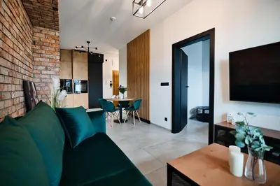 a living room with a couch and a table at Apartament Zator 5 by Housine in Zator