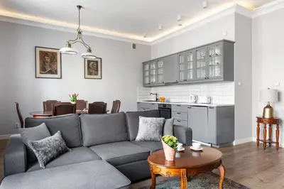 a living room with a gray couch and a table at Apartamenty Starowiślna 1, Kraków Main Square in Kraków
