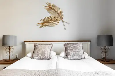 a bedroom with two white beds with pillows at Apartamenty Starowiślna 1, Kraków Main Square in Kraków