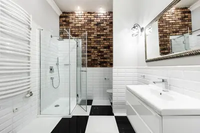 a white bathroom with a glass shower and a sink at Apartamenty Starowiślna 1, Kraków Main Square in Kraków