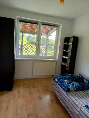 a bedroom with a bed and a large window at W Rajbrocie u Ewusi in Rajbrot