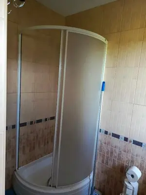a shower stall in a bathroom with a toilet at W Rajbrocie u Ewusi in Rajbrot