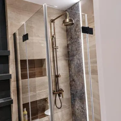 a shower with a glass door in a bathroom at Apartament Bulwary317 in Oświęcim