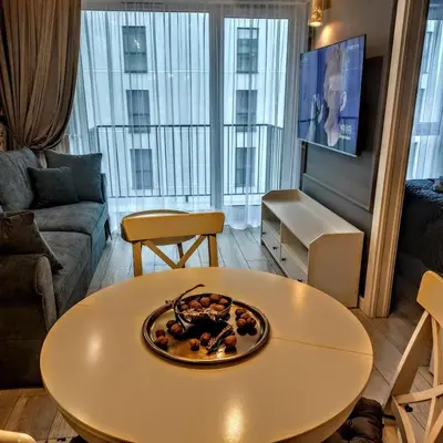 a living room with a table with a plate on it at Apartament Bulwary317 in Oświęcim