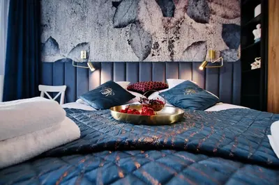 a bed with a bowl of fruit on top of it at Apartament Bulwary317 in Oświęcim