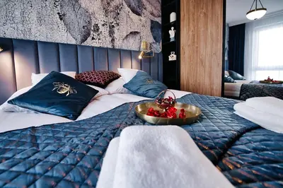 a bedroom with a bed with a bowl of fruit on it at Apartament Bulwary317 in Oświęcim