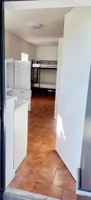 an open door to a room with a bedroom at Noclegi u Ewusi in Januszowice
