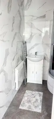 a white bathroom with a sink and a toilet at Noclegi u Ewusi in Januszowice