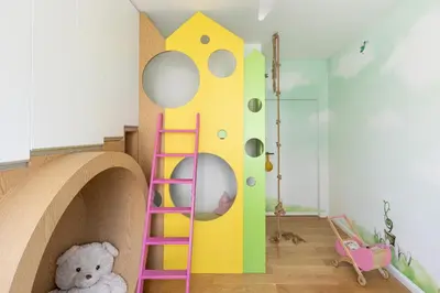 a childs room with a play area with a ladder and a stuffed bear at Miejska Cisza Urban Silence in Kraków