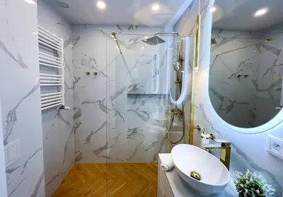 a bathroom with a shower and a toilet and a sink at DS Apartamenty Jaśminowa in Zator